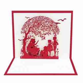 3D pop card silhouette of adult reading to children under tree