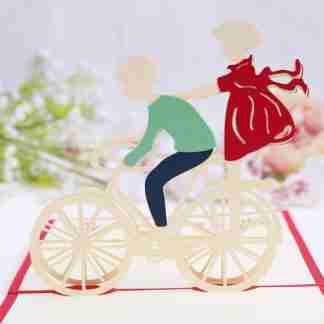 3D pop card of two children riding a bicycle
