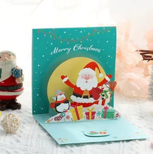 3D pop up Christmas card with Santa and gifts on green background